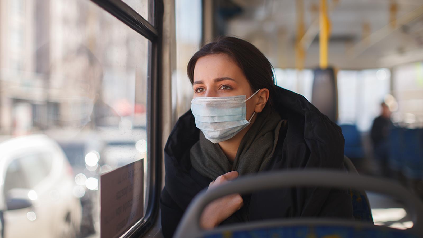 Woman on bus with face mask