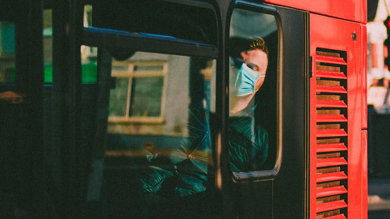 Man in face mask on bus