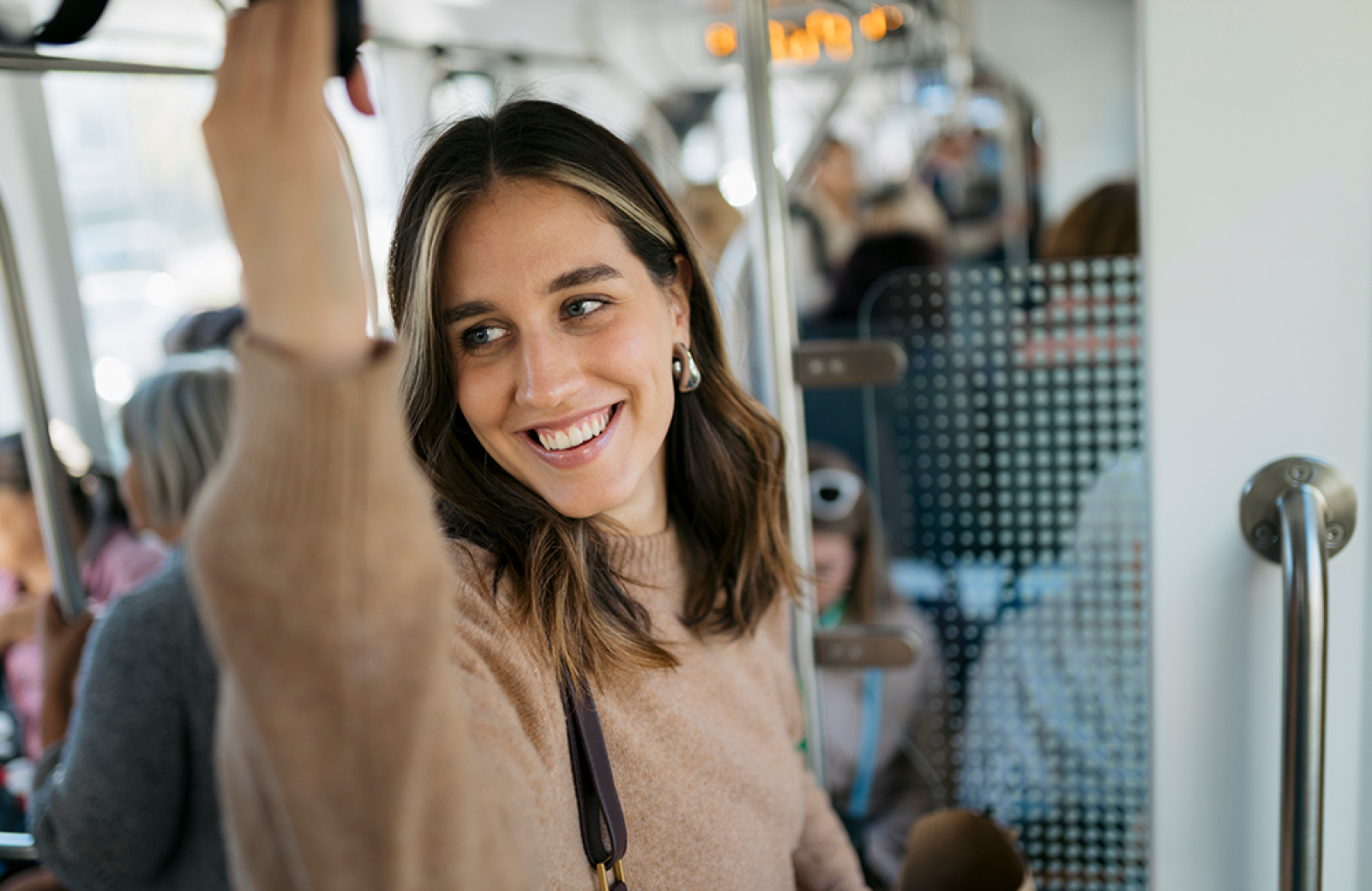 A lady smiling on the bus