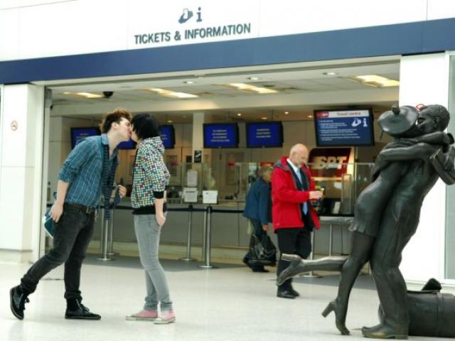 Passengers kissing at station