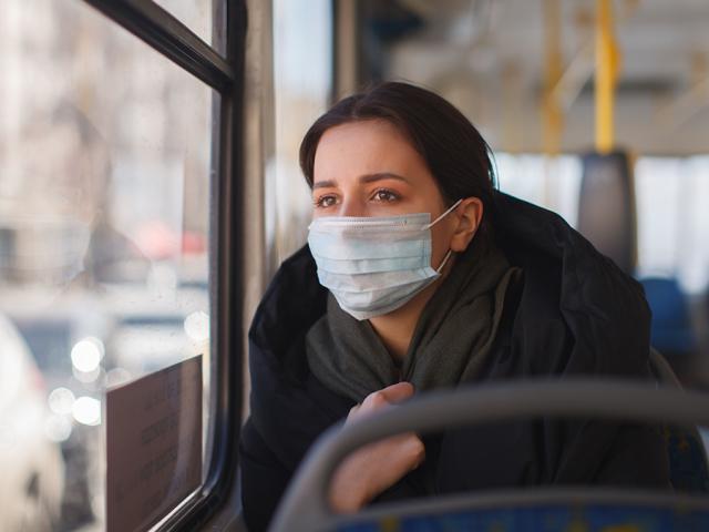 Woman on bus with face mask