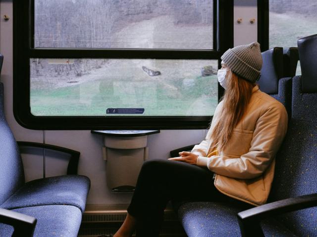 Woman wearing mask on train