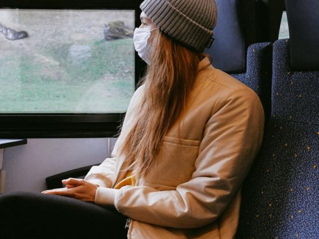 Masked woman on train